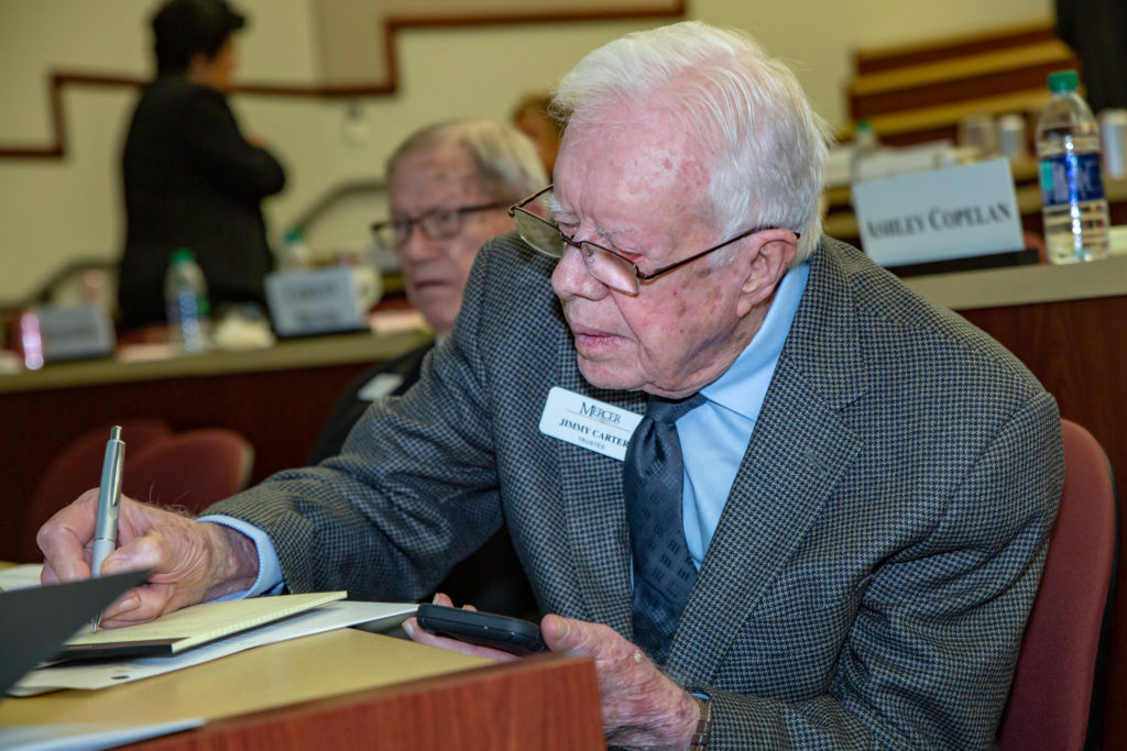 Jimmy Carter writes on a yellow legal pad.