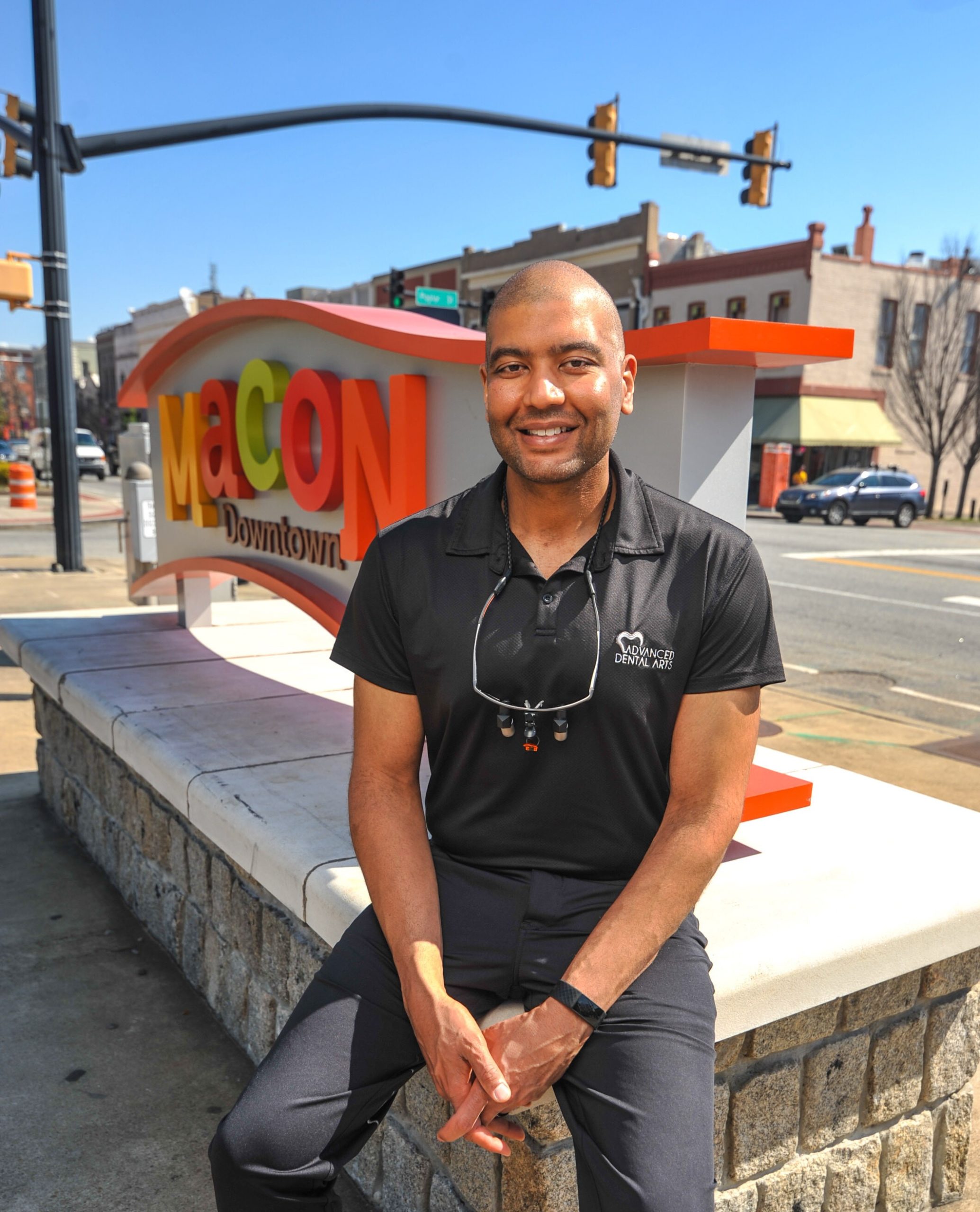 Dr. Samer Othman is shown in from of the Macon sign in downtown Macon.