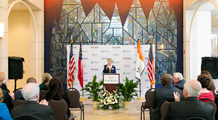 School of Medicine announces community partners in rural pediatric health care initiative dr. jean sumner speaks into a podium in front of a backdrop with the mercer school of medicine, georgia rural health innovation center and children's healthcare of atlanta logos