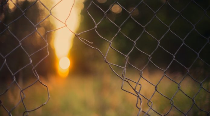 Instead of walling people out, try letting others in broken gray wire fence