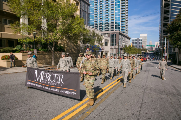 ROTC cadets hold a banner that says Mercer University Georgia's First Purple Heart University