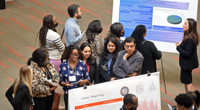 Mercer’s 13th Atlanta Research Conference to showcase student, faculty scholarship people gather to look at a poster
