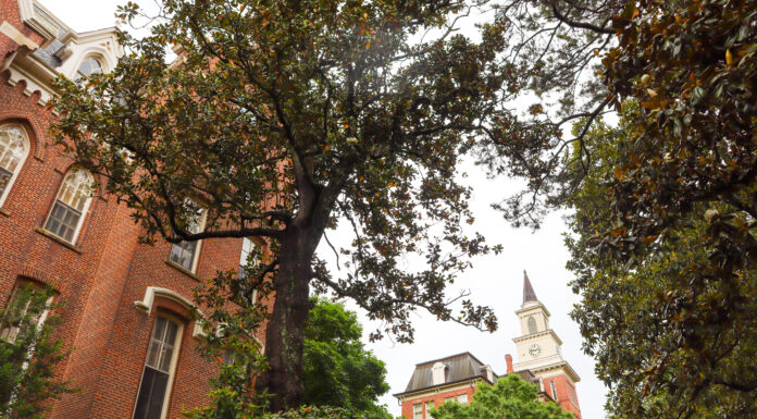 Faculty and Staff Notables | April 2023 The administration building is seen up close, with the top of Willet Hall seen in background through the trees.