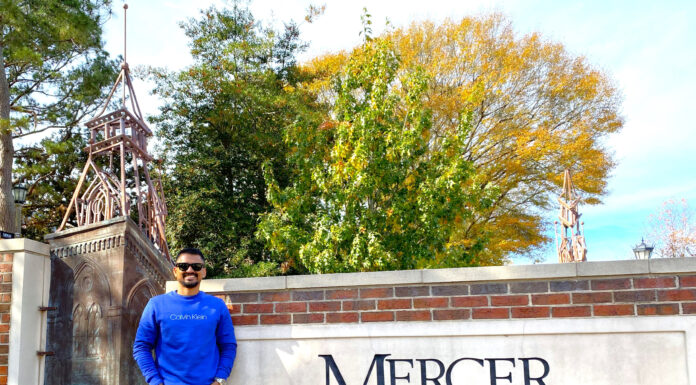Graduate Spotlight: Ahasanul Hasan Ahasanul Hasan stands in front of a Mercer sign