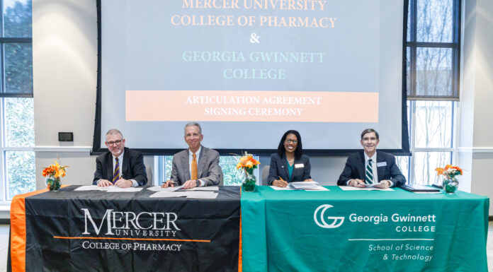 College of Pharmacy, Georgia Gwinnett College sign transfer admission agreement four people sit behind tables signing papers