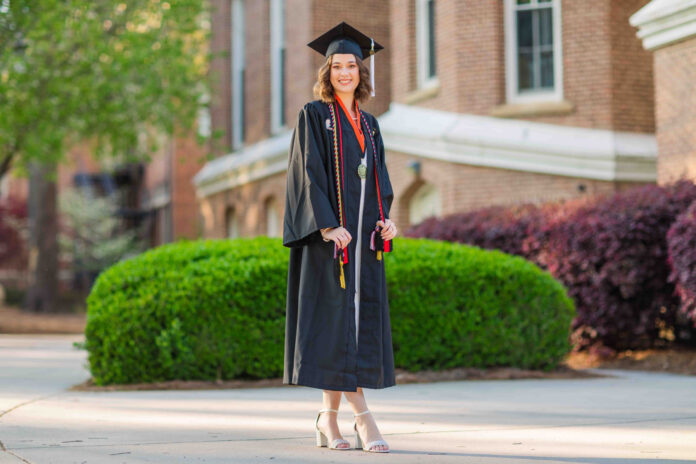Emma Gilliam wears graduation cap, gown and cords