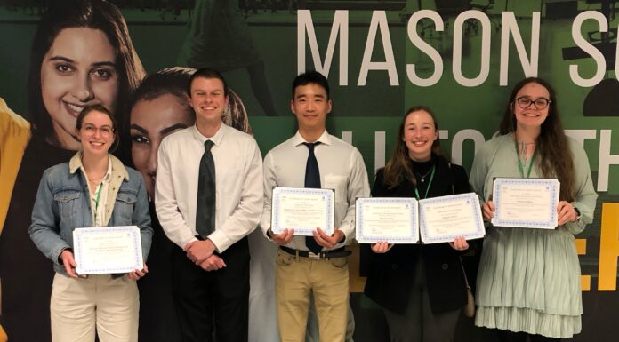 Mercer students win awards at engineering conference’s poster competition Five students stand together and hold their awards.