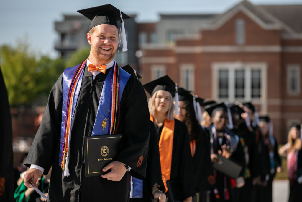 grad holds diploma