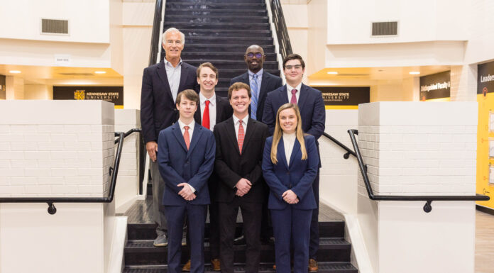 Mercer named runner-up in 2023 CFA Institute Southern Classic Research Challenge A group of students and faculty stand in front of stairs.