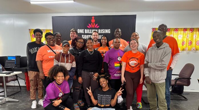 Mercer students teach app development in South Africa A large group of people gathers for a photo inside a building.