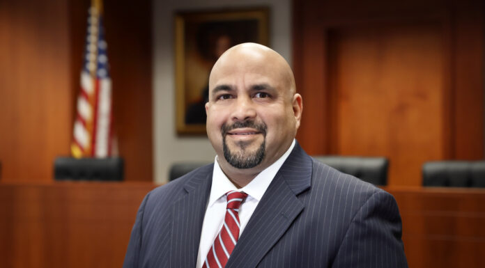 Mercer Law professor takes real-world lessons from practice to academia Ishaq Kundawala stands in a courtroom