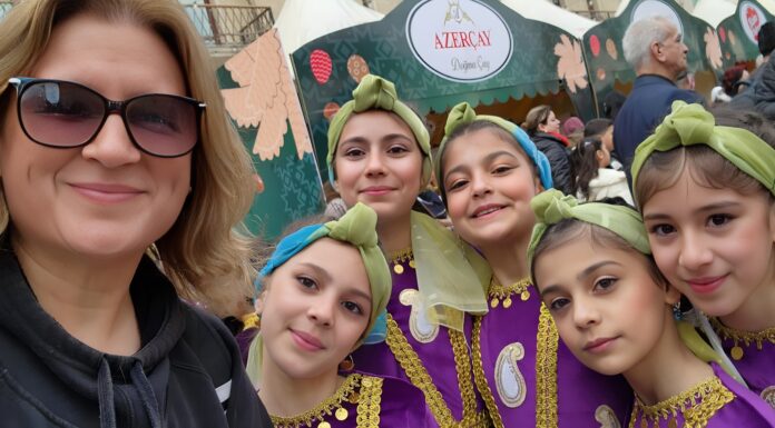 Professor’s experiences in Azerbaijan lead to new Mercer On Mission trip Dr. Jacqueline Stephen takes a photo with five girls in colorful outfits.