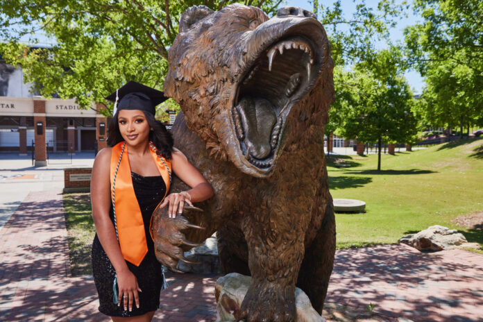madison golphin in front of angry bear statue