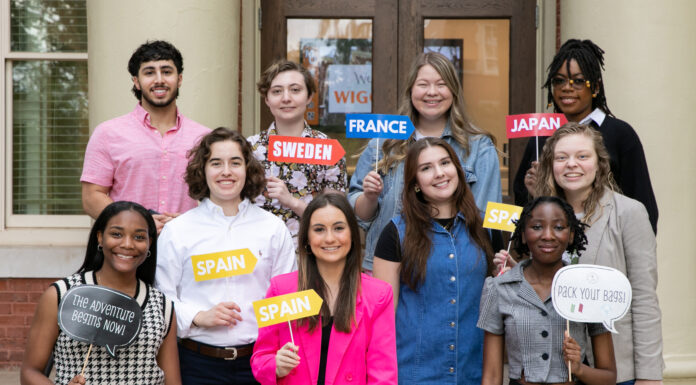 Mercer awards 21 Global Leader Scholarships for study abroad in 2023 Students stand on steps and hold signs with country names