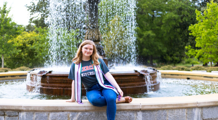 Graduate Spotlight: Mary Helene Hall Mary Helene Hall sits on the edge of a fountain