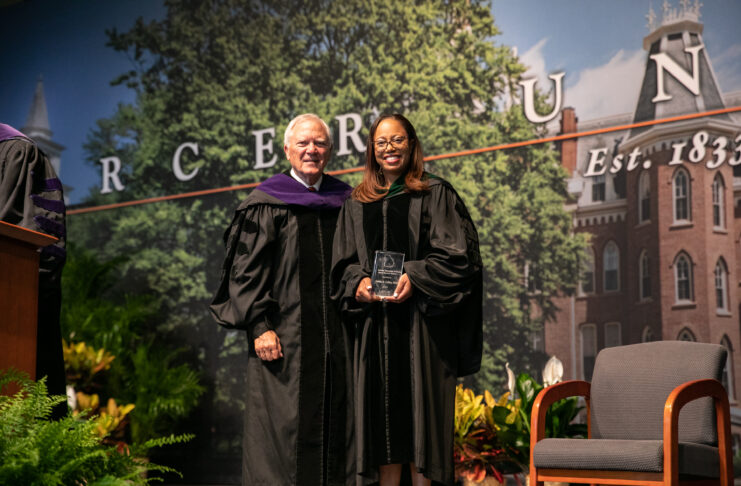 keisha callins holds her award while standing next to former governor nathan deal