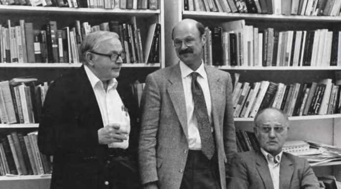 Ted Nordenhaug was University’s ‘philosopher-king’ | Mercer Legends Three men stand in front of a shelf of books.