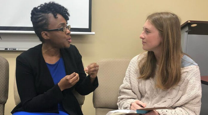 Students’ research to help U.S. engage with Haitian population in Georgia a student and a woman talk