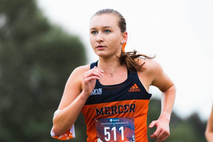 Marina Van Sickle is shown running in her Mercer uniform.