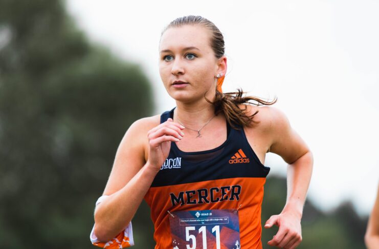 Marina Van Sickle is shown running in her Mercer uniform.