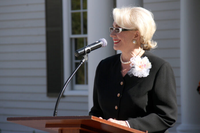 A woman speaks at a podium.