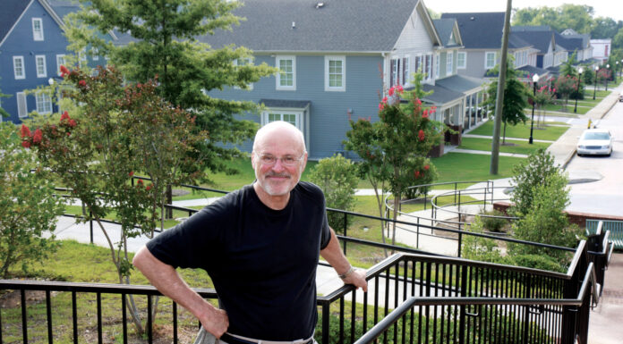 Dr. Peter Brown impacted Mercer and Macon through civic engagement | Mercer Legends a man stands at the top of a brick staircase that overlooks a neighborhood of houses