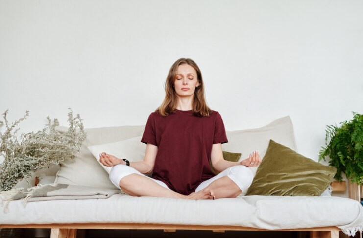 Woman in Red Shirt Sitting on Couch Meditating