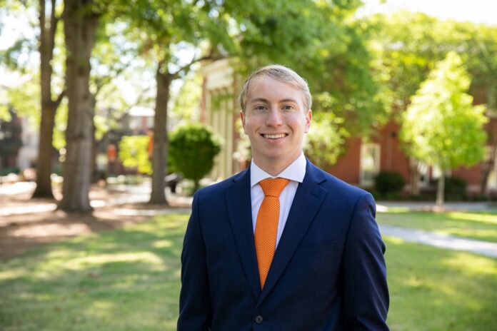 A student in a suit poses for a photo on Mercer's Macon campus.
