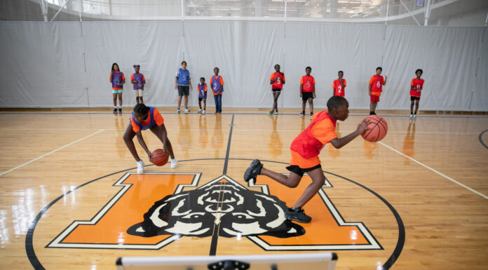 Professor uses basketball to teach kids STEM at camp supported by Trane Technologies kids race to shoot basketballs