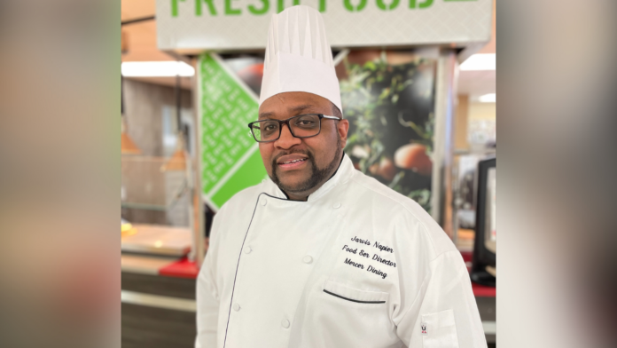 Jarvis Napier wears a chef's uniform and hat.