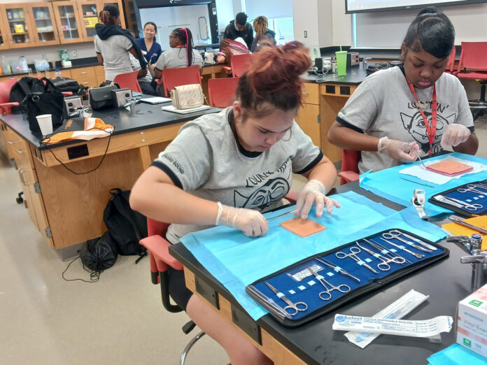 a student practices sutures