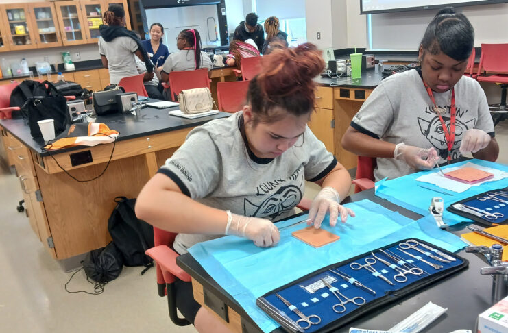a student practices sutures