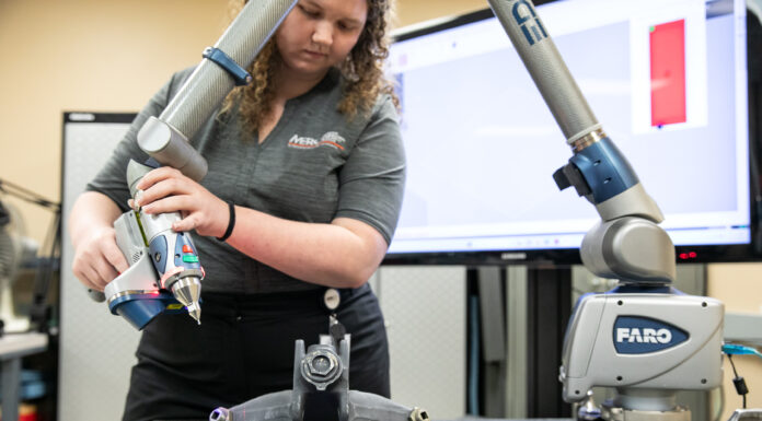 MERC solves real-world problems for the Air Force and other clients A woman points a laser at an aircraft part.