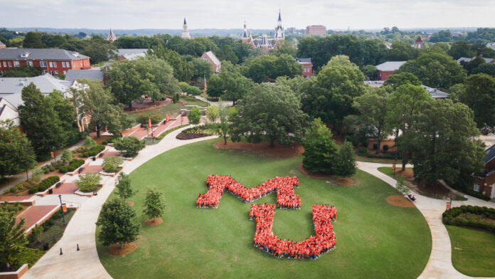 aerial of students forming the letters MU on field