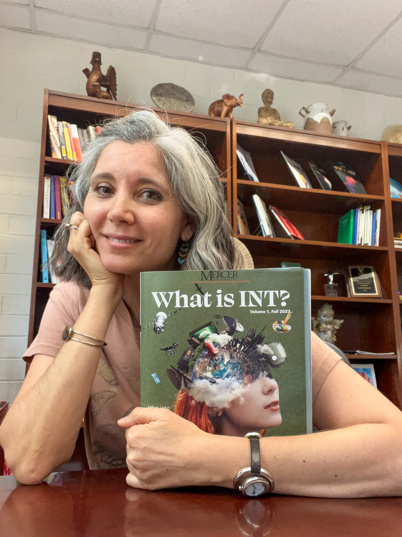 dr clara mengolini shows off the cover of the what is int? magazine