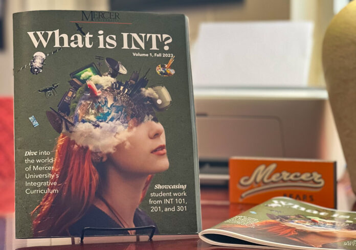 what is int? magazine is on display on a desk