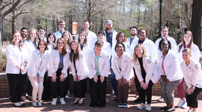 NCPA awards Chapter of the Year to Mercer College of Pharmacy student chapter a group of people in white coats pose for a photo