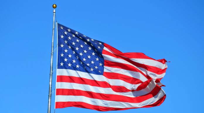 Patriotism and democracy kick off McDonald Center lecture series American flag flies against blue sky