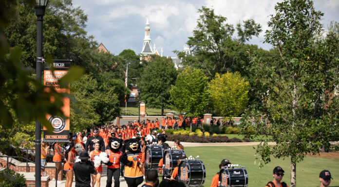 3 things to know about Mercer vs. Chattanooga football game day: Oct. 14, 2023 percussionists, toby and tot mascots, cheerleaders and football players process down a sidewalk