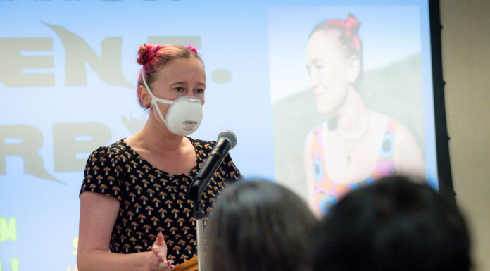Third Thursday Reading Series fosters writing community at Mercer a woman talks into a microphone at a podium