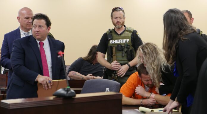 Mercer Law professor, students help exonerate Georgia man of murder charges A woman hugs a man in an orange jumpsuit, while co-counsel and a sheriff's officer stand around them.