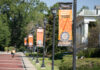 Office of Global Engagement awards 27 scholarships for students to study abroad Exterior campus street posts with orangge banners stating "At Mercer Everyone Majors In Changing the World"