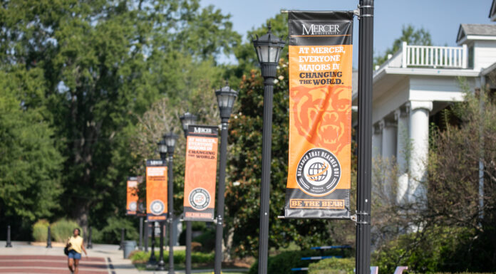 Office of Global Engagement awards 27 scholarships for students to study abroad Exterior campus street posts with orangge banners stating "At Mercer Everyone Majors In Changing the World"