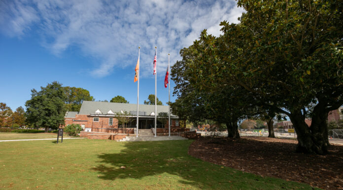 Mercer to dedicate Freedom Plaza and Kicklighter Hall during Homecoming a grassy field in front of a building.