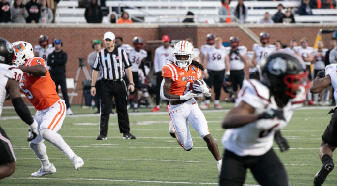 Mercer beats Gardner-Webb in first round of FCS playoffs A football player wearing orange runs the ball
