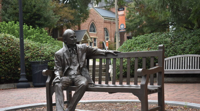 Board elects new trustees and officers life-size statue of man (Jesse Mercer) sitting on a park bench