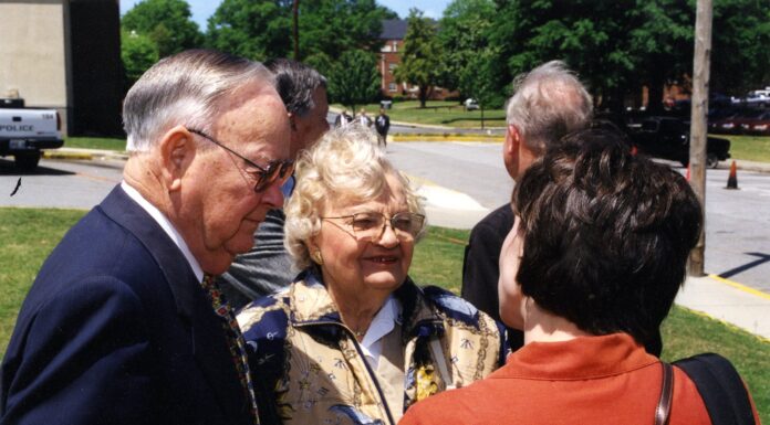 Howard and Gladys Giddens opened their hearts, home to Mercer family | Mercer Legends A couple stands and talks with a woman outside.