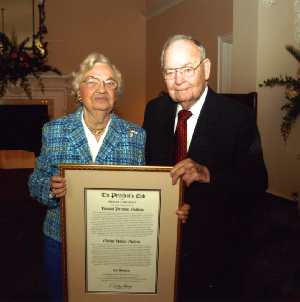 A couple holds a plaque.