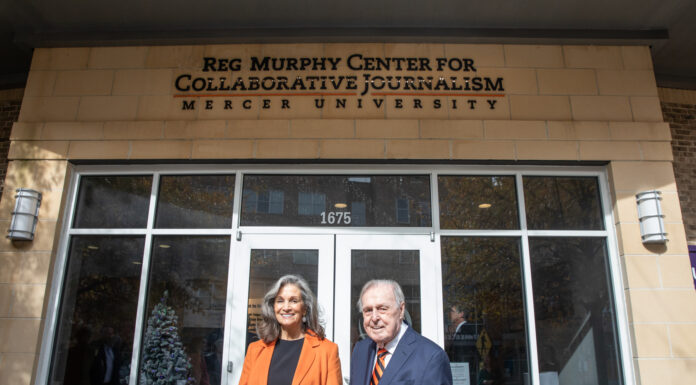 In the face of challenges, Mercerian never stopped seeking the truth man and woman stand in front of a building that bears the name Reg Murphy Center for Collaborative Journalism
