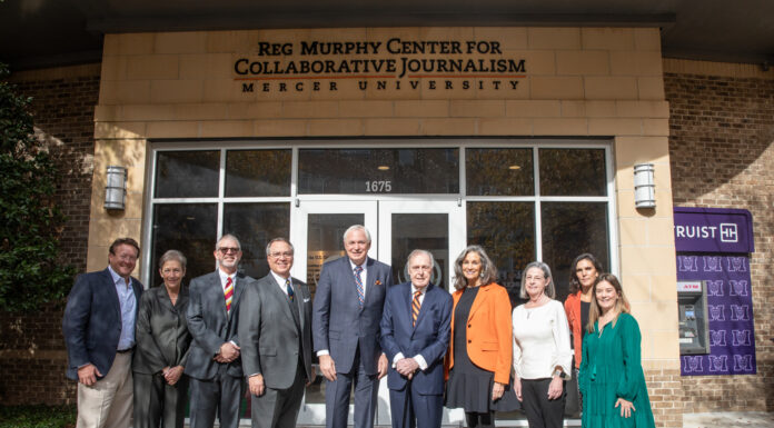 Journalism scholarship honoring Reg Murphy established by Omnicom A group of people stand in front of a building that bears the name Reg Murphy Center for Collaborative Journalism
